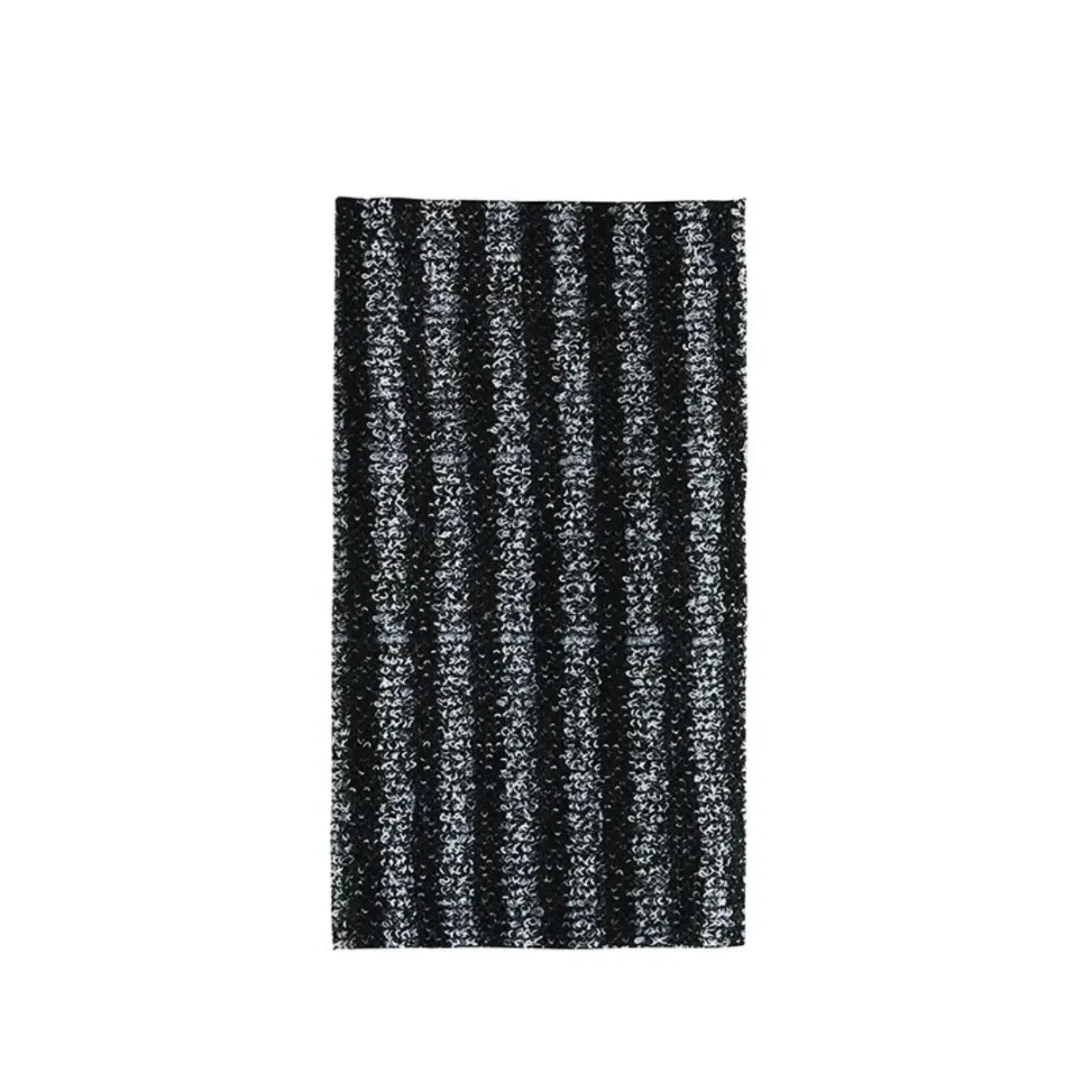 A close-up of a black and white striped exfoliating loofah scrubber.