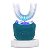 A teal ultrasonic electric toothbrush with a clear head and white base sits on a white platform.