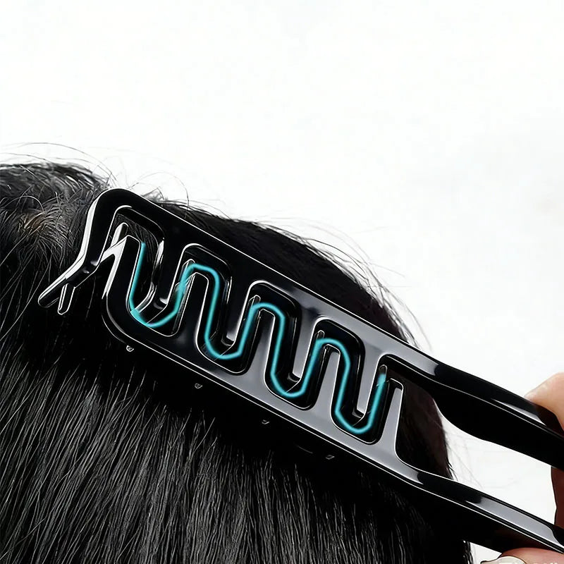 A black hair styling comb with blue LED lights is shown being used on dark hair.