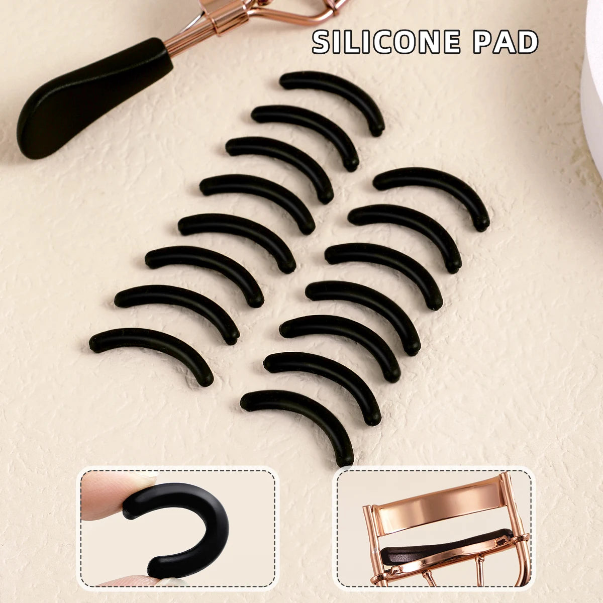 A set of black silicone eyelash curler pads and a stainless steel curler tool.