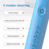 A close-up of a light blue ultrasonic electric toothbrush with various cleaning modes displayed on the side.