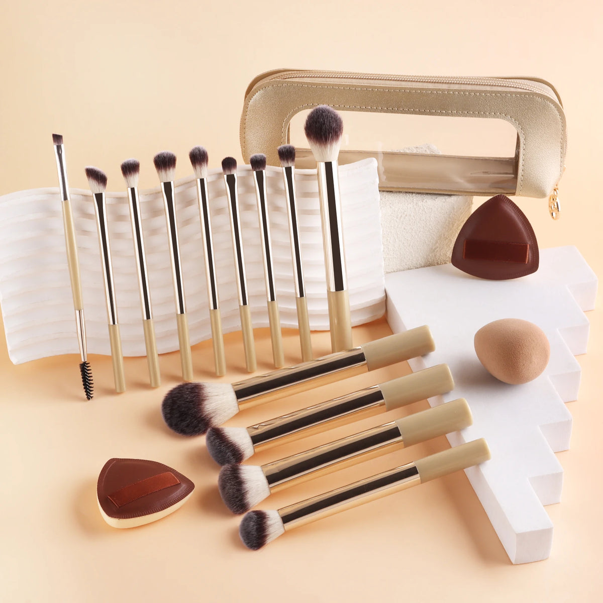 A set of thirteen professional makeup brushes and a storage bag displayed on a light beige background.