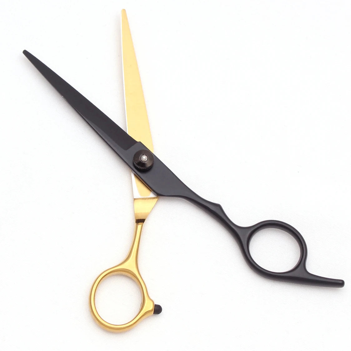 A pair of professional stainless steel hairdressing scissors with gold and black handles.