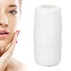 Roll of white facial hair remover threader with a woman's face in the background
