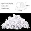 A pile of white heart-shaped disposable glue rings for eyelash extensions and nail art