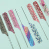 A collection of anti-static rat tail combs in various shades of pink, purple, and multicolored patterns.