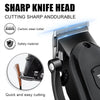 A close-up view of a black electric hair clipper head with a sharp cutting blade and safety features.