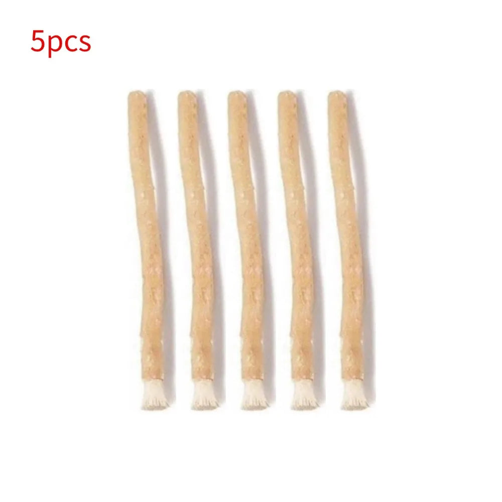 Five natural miswak toothbrushes displayed in a row.