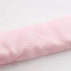 A soft pink removable heatless hair curler for overnight styling.