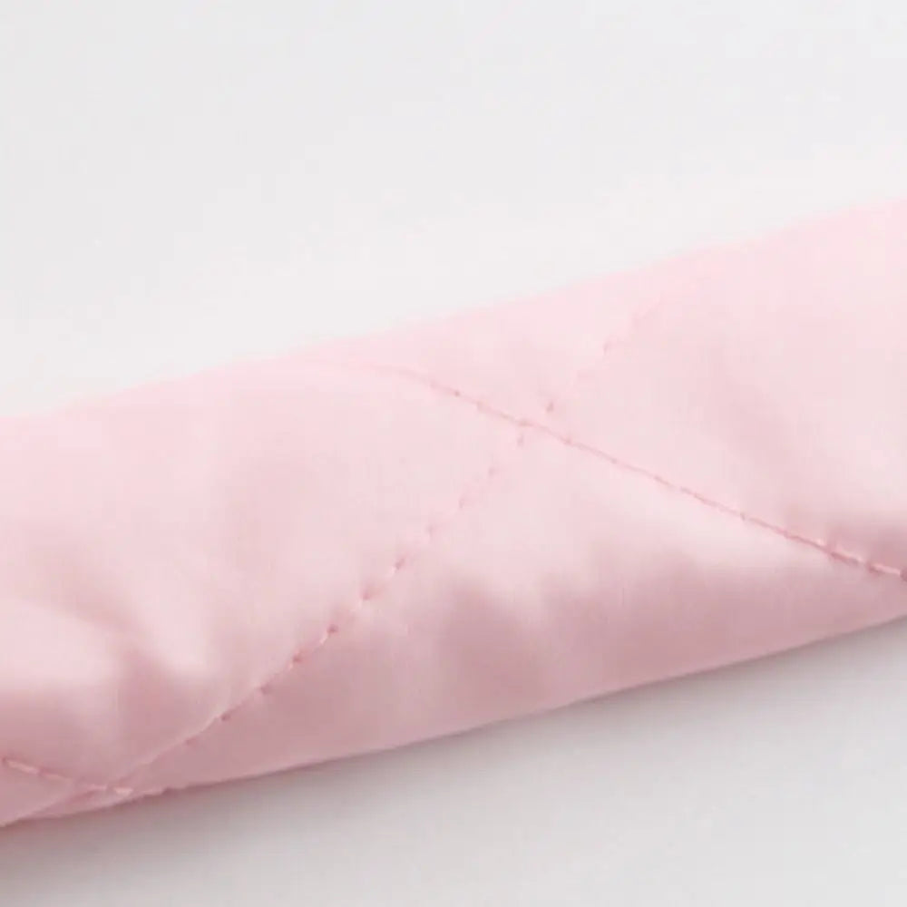 A soft pink removable heatless hair curler for overnight styling.