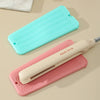 A pink silicone mat is shown next to a light blue silicone mat and a white hair styling tool.