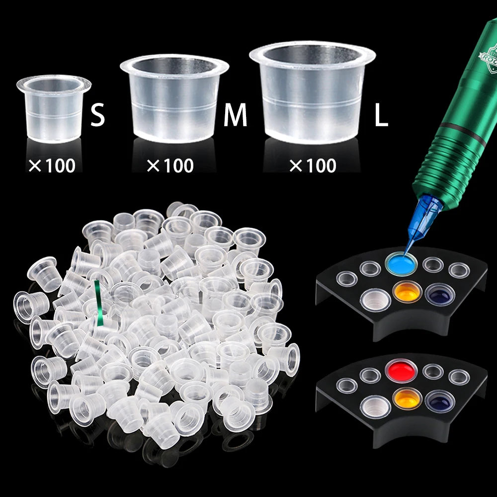 A set of tattoo ink cups with holder, showing sizes S, M, and L, along with a dispenser and color palette.