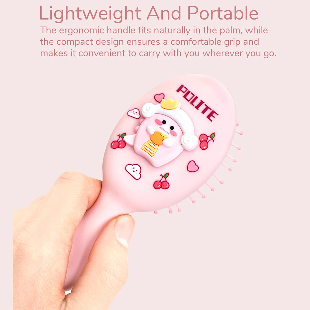 A hand holds a pink cartoon mini air cushion massage comb with fruit and heart designs.