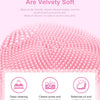 Pink silicone facial cleansing brush with fine bristles shown against a white background.