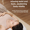 A woman is lying down using an electric massage pillow on her neck and back.