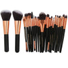 A collection of 22 professional makeup brushes in black and rose gold tones.