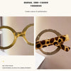 Pair of round tortoiseshell acetate reading glasses with light brown frames and clear lenses