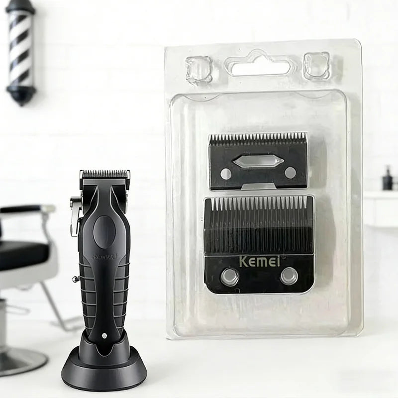 A black hair clipper replacement blade is shown next to its clear plastic packaging.