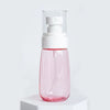 A pink glass spray bottle with a white pump dispenser for hair and wigs.