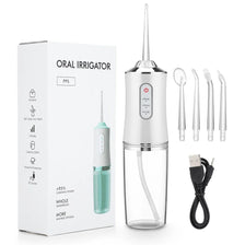 A portable oral irrigator device in silver and green is shown with its cleaning tube and charging cable.