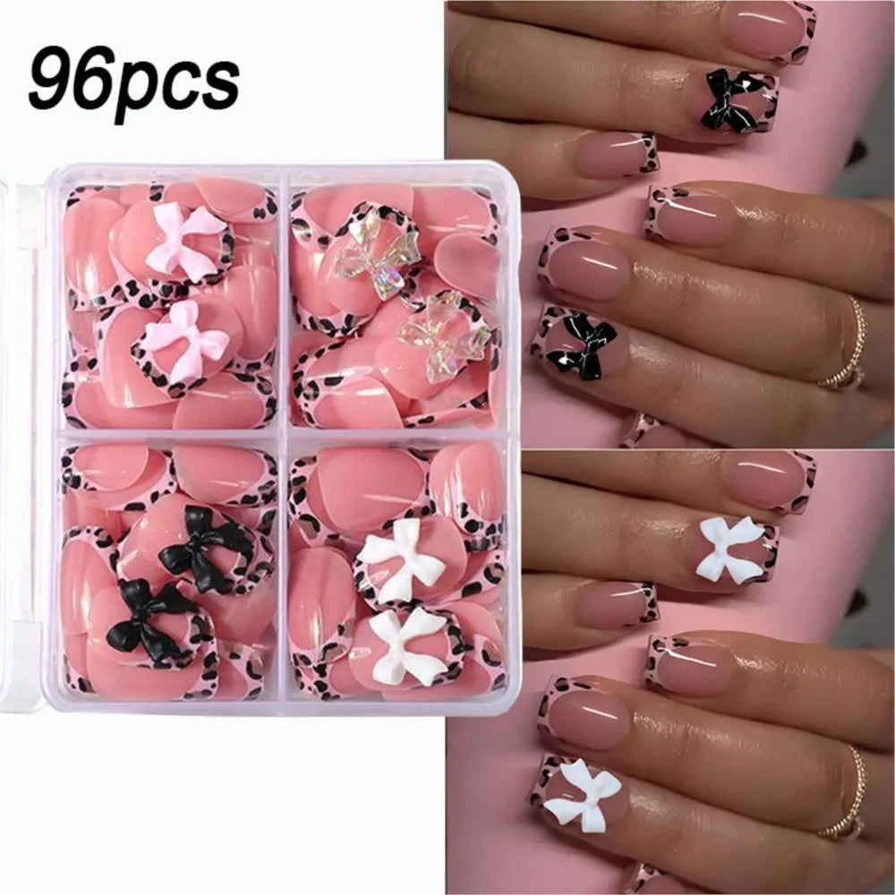 A box of 96 press-on nails featuring pink and black leopard print designs on manicured fingers.