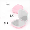 Pink compact LED makeup mirror showing 1X and 5X magnification settings.