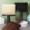 A set of black and cream soft bristle hair duster brushes displayed on a gray surface.
