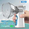 A hand holds a white mesh nebulizer with a blue mouthpiece and battery, against a light blue background.