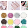 A collection of twelve loose glitter powders in various colors displayed in small circular containers.