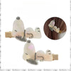 A set of two white Snoopy cartoon hair clips featuring black outlines and gold accents.