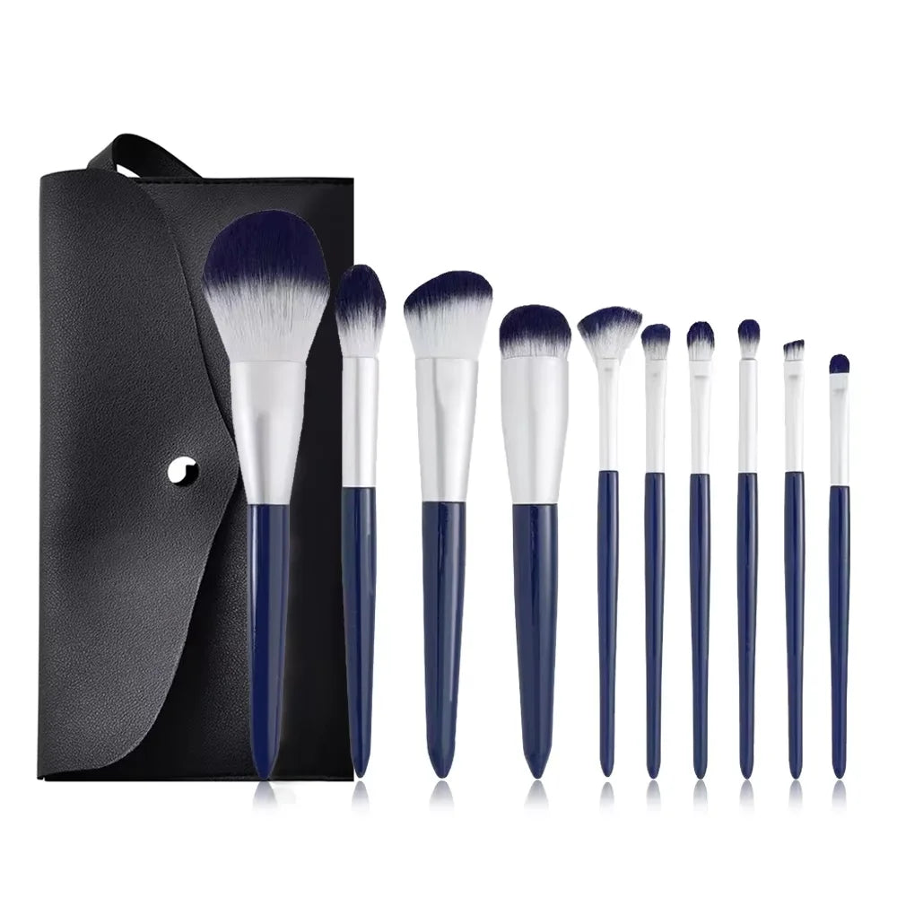 A set of professional makeup brushes with dark blue and black handles displayed on a black background.