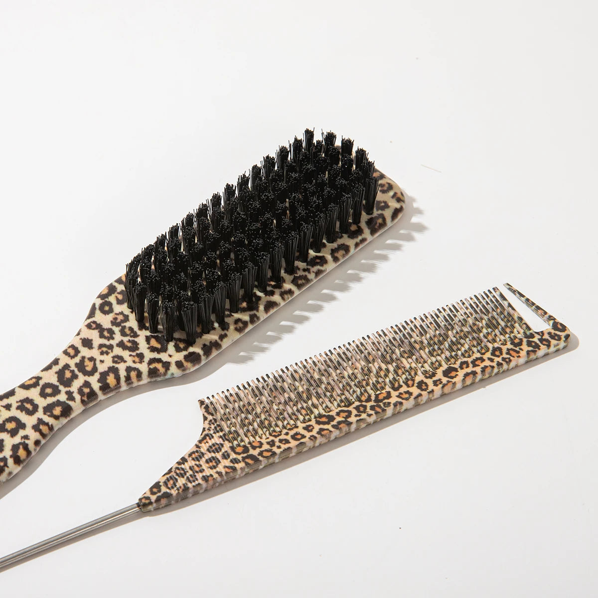A set of two leopard print pointed tail hair combs, one is a brush and the other is a comb.