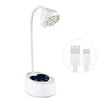 A white professional UV LED nail lamp with an adjustable arm and a light panel, shown next to its power adapter.