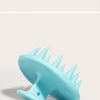 Brosse de massage pour le cuir chevelu en silicone bleu clair à poils pointus.