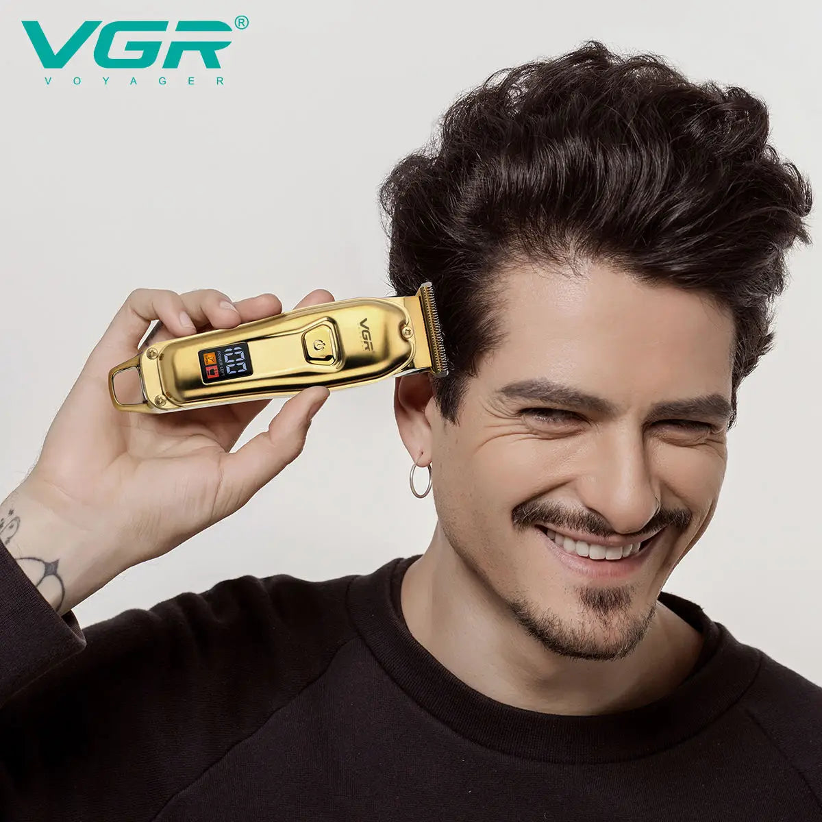 A man holds a gold-colored VGR electric hair clipper against his head.