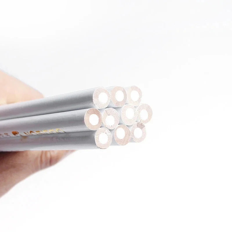 A hand holds a set of nail art rhinestone wax picker pencils, showing the tips and barrel of the pencils.