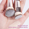 A hand holds a set of professional makeup brushes featuring soft gray and blonde fiber wool bristles.