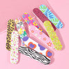 A collection of colorful double-sided nail files and buffing blocks featuring various patterns like leopard print, floral des