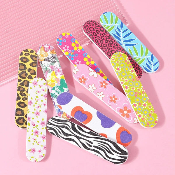 A collection of colorful double-sided nail files and buffing blocks featuring various patterns like leopard print, floral des