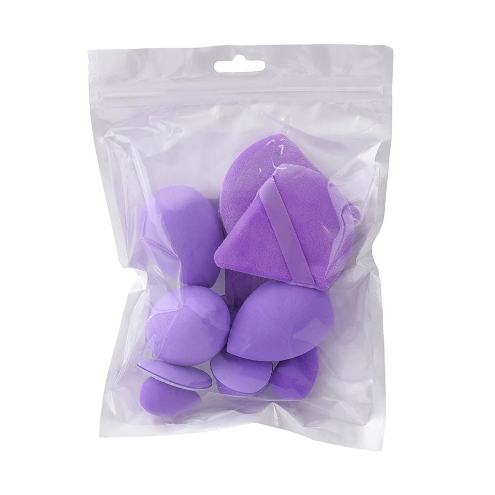 Set of translucent purple makeup sponges in various shapes and sizes inside a clear plastic bag.