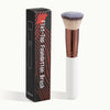 A black box containing a flat-top foundation brush with a white handle and a dense, light brown bristles.
