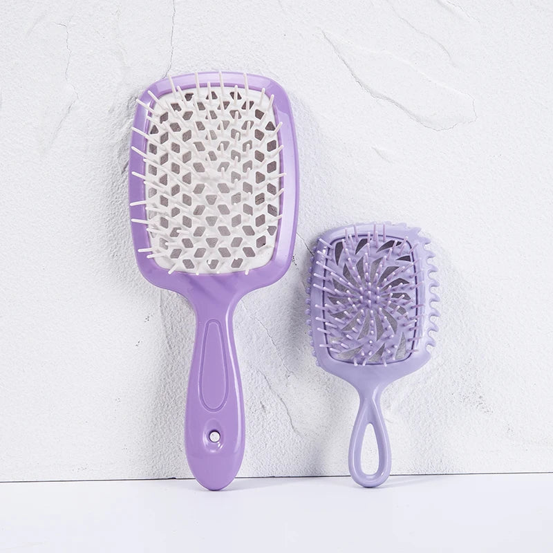 A pair of purple detangling hair combs, one large and one small, are displayed against a white background.