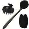 Black long handle silicone body brush with a textured head for shower and bath use