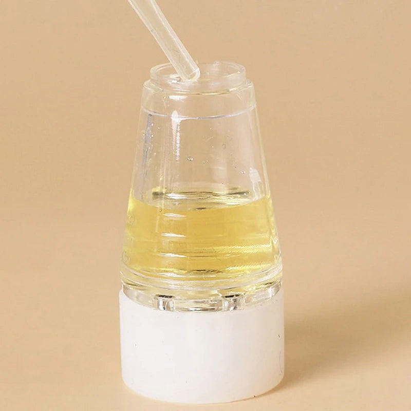 A clear glass dropper bottle containing yellow oil or serum with a white pipette and a white cap.