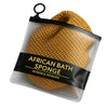 A clear plastic bag containing a yellow African bath sponge with a black drawstring.