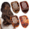 A set of four oval flat hair clips in a leopard print pattern shown against a dark background.