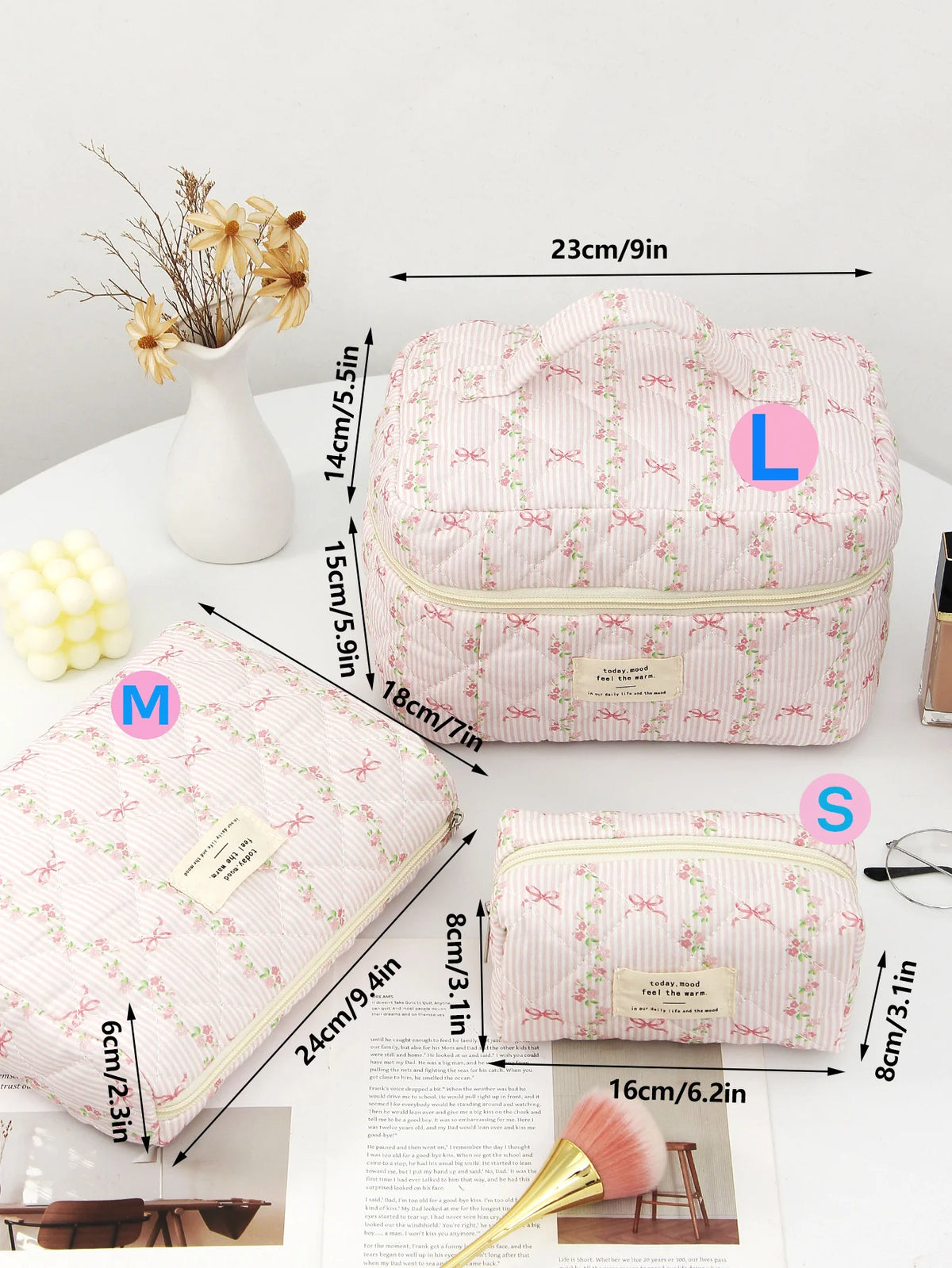 Pink quilted cotton makeup bag with zipper closure shown next to measuring tape and cosmetic brush.