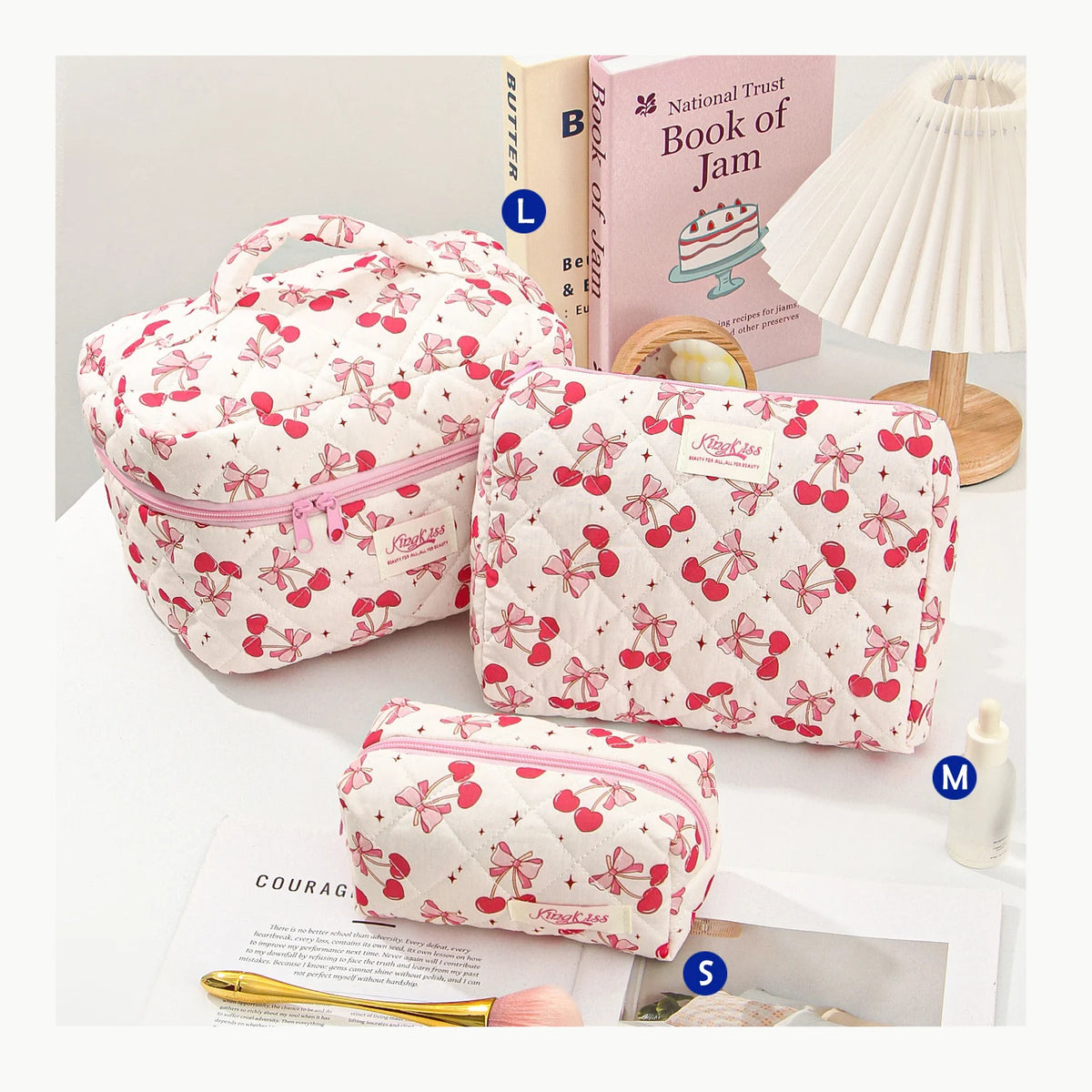 A pink quilted cotton makeup bag with a zipper closure is shown next to a book and a white lamp.