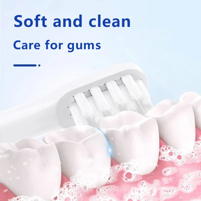 White replacement toothbrush heads being used on a pink toothbrush, emphasizing soft and clean care for gums.