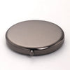 A round, metallic makeup mirror with a folding design and magnifier.